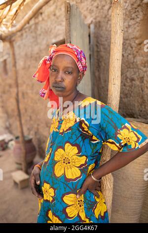 Aichata Barry (28) und ihre Kinder flohen vor Gewalt und Unsicherheit in der zentralen Stadt Mopti, um in der stabileren Region Segou in Mali zu leben. Seit ihrem Umzug in die Gegend hat die Familie mit dem Tod ihres einzigen Sohnes sowie der nicht diagnostizierten Krankheit Aichatas, die traditionelle Heiler nur noch verschlimmern zu können schienen, eine Tragödie erlitten. Nun bleibt Aichatas älteste Tochter, die zwölfjährige Korka, von der Schule zu Hause, um die meisten Aufgaben zu erledigen, da Aichata zu schwach und müde ist, um zu arbeiten. Ihre einzige Aktivität ist es, Palmwedel in Fächer und Matten zu weben, um sie an die Nachbarn zu verkaufen. Der Ehemann von Frau Barry hat lef Stockfoto