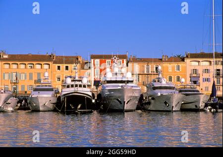 FRANKREICH. PROVENCE. VAR (83) SAINT TROPEZ. DER HAFEN UND DAS MEER IN DER UNTERGEHENDEN SONNE Stockfoto