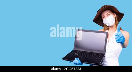 Das Nahaufnahme-Foto einer Frau in medizinischer Maske und Handschuhen, die das Zeichen in Ordnung macht und online zu Hause in Quarantäne arbeitet. Stockfoto