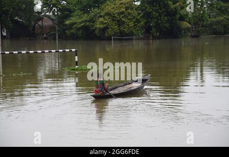 Guwahati, Guwahati, Indien. August 2021. Eine Frau rudert ihr Boot am Sonntag, dem 29. August 2021, durch das Hochwasser des vom Hochwasser betroffenen Dorfes im Distrikt Morigaon in Assam Indien.der Anstieg des Wasserpegels in verschiedenen Flüssen des Staates verursacht eine Überschwemmung in fast 15 Distrikt von Assam und verursacht Schäden an den Kulturen (Bildnachweis: © Dasarath Deka/ZUMA-Pressdraht) Stockfoto