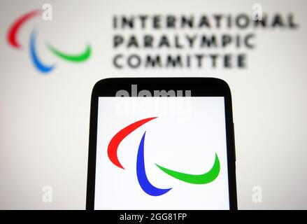 In dieser Abbildung ist das Logo der Paralympischen Spiele (Paralympics) auf einem Smartphone-Bildschirm vor dem Logo des Internationalen Paralympischen Komitees (IPC) im Hintergrund zu sehen. Stockfoto