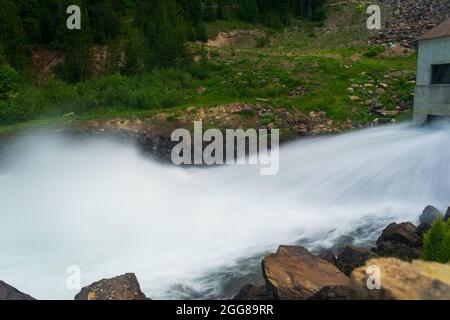 Wasser kommt aus dem Staudämmungsgebäude am Bergsee, USA Stockfoto