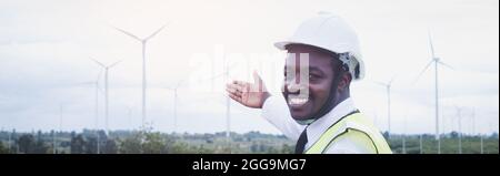 Afrikanische Ingenieure, die vor Ort mit Propeller für Windkraftanlagen und klarem blauen Himmel im Hintergrund arbeiten. Alternative Energie, umweltfreundlich fo Stockfoto