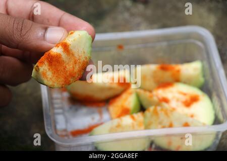 Guava Stücke bestreut mit Salz und rotem kühlem Pulver, würzige Schüssel mit Guava bereit, gegessen werden Stockfoto