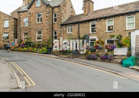 HAWES, Großbritannien - 23. AUGUST 2021: Hawes ist eine Marktstadt im Herzen von Yorkshire Dales mit Steingebäuden, Geschäften und Häusern, die durch gepflasterte Straßen miteinander verbunden sind Stockfoto