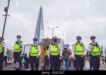 London, Großbritannien. August 2021. Demonstranten und Polizei auf der London Bridge. Extinction Rebellion Demonstranten marschierten im Rahmen ihrer zweiwöchigen Kampagne „Impossible Rebellion“ von News UK zur Tower Bridge. (Kredit: Vuk Valcic / Alamy Live News) Stockfoto