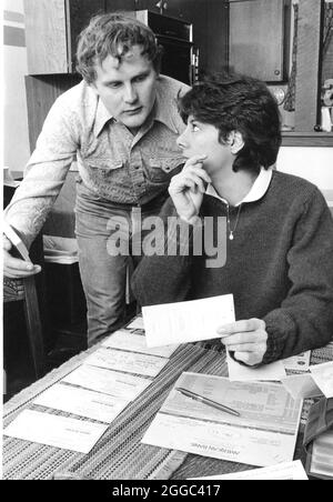 ©1986 Anglo Paar in den 30er Jahren, das Budgets macht und das Girokonto zu Hause ausbalanciert. Bob und Janis Daemmrich Stockfoto