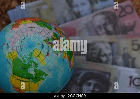 Erdglobenkarte der Arktis, die in der Natur auf einer Gruppe von Banknoten sitzt. Stockfoto