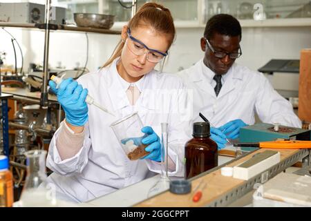 Junge Wissenschaftlerin, die im Forschungslabor arbeitet und Experimente durchführt Stockfoto