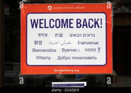 Ein Schild an der Tür der Lefferts Library in Richmond Hill begrüßt Besucher in 11 verschiedenen Sprachen. Stockfoto