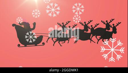 Digitales Bild von Schneeflocken fallen über die schwarze Silhouette des weihnachtsmanns im Schlitten Stockfoto
