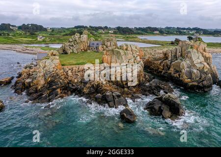 Drohne aus dem Atlantischen Ozean auf die Granitküste von Plougrescant mit Blick auf das Haus zwischen den Felsen (Le gouffre de Plougrescant) Stockfoto