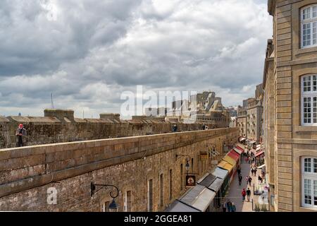 Blick von der Stadtmauer in eine Gasse der Altstadt mit bunten Markisen von Saint Malo, Bretagne, Frankreich Stockfoto