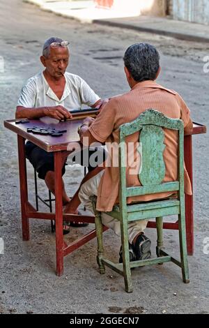 Zwei dunkelhäutige alte Männer, Kubaner, die auf der Straße an einem Tisch sitzen und Dominosteine spielen, Hauptstadt Havanna, Provinz Havanna, Großantillen, Karibik Stockfoto