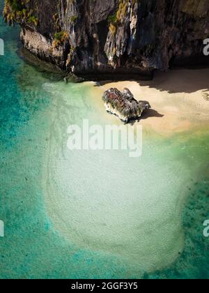 Luftdrohne schoss direkt auf einen Strand von Railay, Thailand, mit klarem Wasser und Felsen in der Nähe. Stockfoto