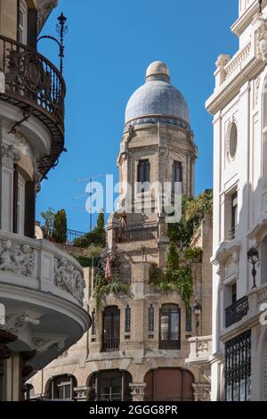 Schöne Terrassen mit Pflanzen in den Dachböden eines Gebäudes mit einer Kuppel auf dem Dach am Rande der Gran Via in Madrid Stockfoto