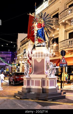 MOSTA, MALTA - 15. Aug 2021: Statue der Muttergottes, Straßendekoration anlässlich des Titularfestes von Mosta, der Himmelfahrt der Muttergottes. Malta, Mediterra Stockfoto