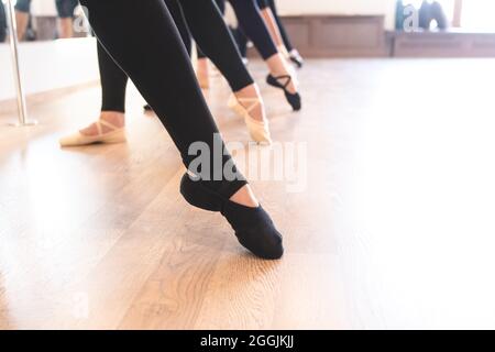 Tiefer Teil der anmutigen Beine von Balletttänzern, die in einer Reihe auf ihren Zehen stehen Stockfoto