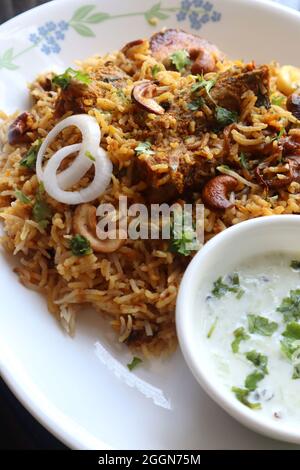 Huhn Biryani oder Murgh Pulao. Garniert mit gebratener Zwiebel, Cashewkernen und Koriander. Biryani ist ein berühmtes würziges, nicht-vegetarisches Gericht Indiens. Stockfoto