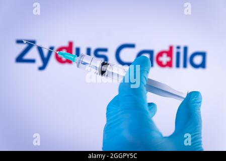 Esp. September 2021. In dieser Abbildung hält eine Hand in medizinischen Handschuhen am 2. September 2021 eine Spritze vor dem Zydus Cadila-Logo in Barcelona, Spanien. Zydus Cadila ist ein indisches Unternehmen, das den Covid-19-Impfstoff CNBC-TV18 entwickelt, auch bekannt als ZyCoV-D. (Foto von Davide Bonaldo/Sipa USA) Quelle: SIPA USA/Alamy Live News Stockfoto