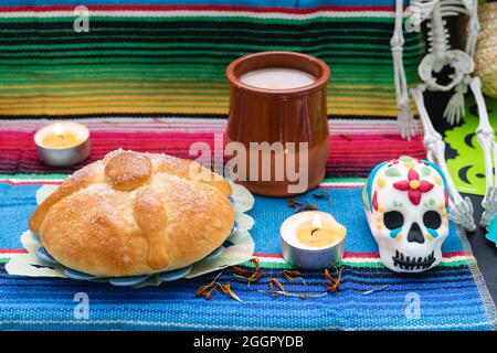 Pan de muerto, Totenköpfe und Kerzen auf dem Totenaltar. Traditionelle mexikanische Feier. Stockfoto