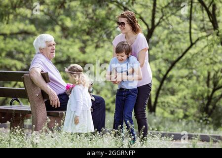 Drei Generationen Familie im Sommerpark: Großvater, Mutter und Enkel. Glückliche Familie im Freien. Stockfoto