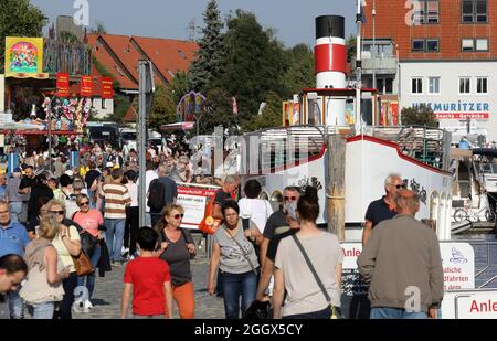 03. September 2021, Mecklenburg-Vorpommern, Waren (Müritz): An der Müritz Sail im Stadthafen sind Besucher unterwegs. Vom 02. Bis 05.09.2021 findet die 19. Müritz Sail in etwas kleinerer Form statt als zuvor. Es wird eine Reihe maritimer Erlebnisse auf dem Wasser geben und ein Volksfest, das sich über das gesamte Stadtzentrum erstreckt. Foto: Bernd Wüstneck/dpa-Zentralbild/dpa Stockfoto