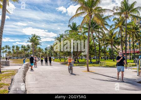 Miami Beach, USA - 20. Januar 2021: Menschen, die auf der Strandpromenade im öffentlichen Park Lummus am Ocean Drive im Art-Deco-Viertel von South Beach spazieren, Stockfoto