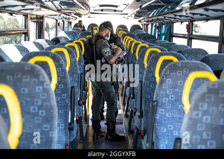 Ost-Jerusalem, Israel. September 2021. Bewaffnete israelische Streitkräfte Soldaten der Grenzkontrolleinheit, die die Beschränkungen des öffentlichen Verkehrs Covid-19 in Ostjerusalem durchsetzen. Geldstrafen für diejenigen, die keine Maske tragen. Laut den Busfahrern ist dies in den letzten Wochen ein lockeres Ereignis in den palästinensischen Gebieten der Stadt. Palästina / Israel, Jerusalem. September 2021. Kredit: Matan Golan/Alamy Live Nachrichten Stockfoto