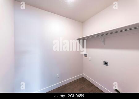 Leere Waschküche eines Hauses mit weißer Wand innen Stockfoto