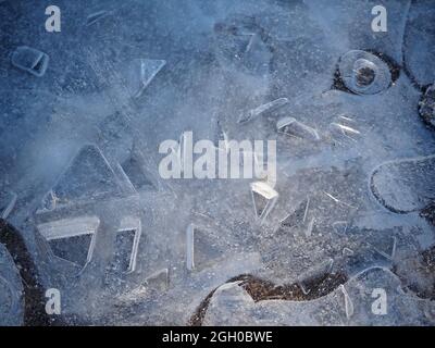 Sonnenschein auf zahlreichen zufälligen dreidimensionalen geometrischen Formen in Eismuster auf gefrorenen Pfützen in Hochlandfells im Winter - Cumbria, England, UK Stockfoto