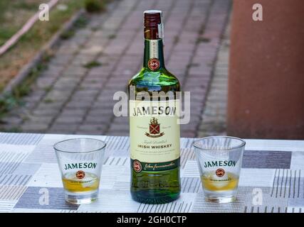 Flasche irischer Whiskey Jameson mit zwei Gläsern. Prost mit Freund. Stockfoto