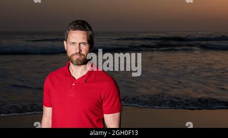 Sommer Mode Stil. Sommerurlaub. Positive Emotionen. Copy Space. Mann mit Bart in Sonnenuntergang Stockfoto