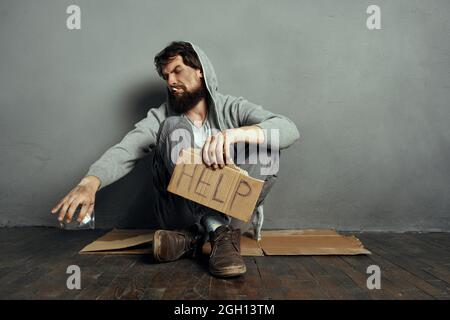 Obdachloser bärtiger Mann auf der Erde bettelt Geld Problem Stockfoto