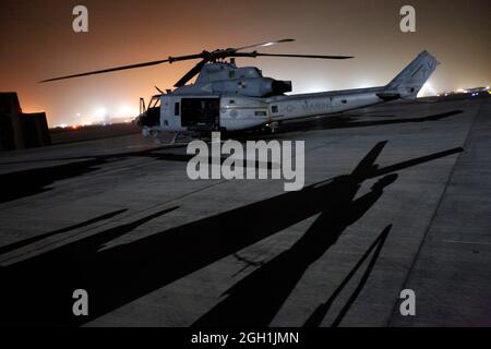 US Marine Lanze CPL. Daniel L. Wiggins, rechts unten, ein Avionik-Techniker mit Marine Light Attack Helicopter Squadron 167, hält den Heckrotor eines UH-1N Huey neben einem AH-1W Super Cobra Hubschrauber in Camp Bastion, Provinz Helmand, Afghanistan, 24. Juni 2013. Wiggins verdrahtete ein 90-Grad-Getriebe neu, um andere Wartungsarbeiten für den Rotor zu erleichtern. (USA Marine Corps Foto von Sgt. Gabriela Garcia/Freigegeben) Stockfoto