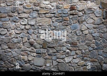 Alte Wand aus Naturmaterial aus Granitblöcken für grafisches Design Stockfoto