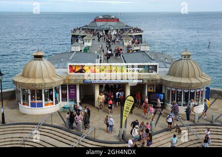 Blick von oben auf die Menschen auf dem geschäftigen Pier mit dem Pavilion Theatre an der Küste in Cromer Norfolk Stockfoto