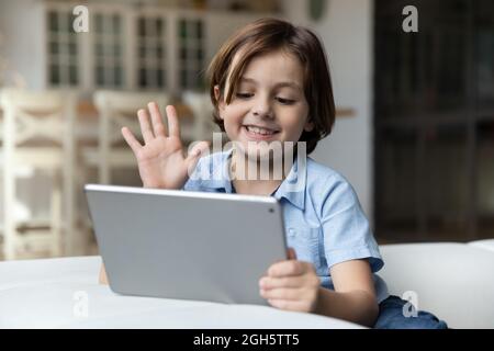 Lächelnder kleiner Junge mit Videoanruf auf einem digitalen Tablet. Stockfoto