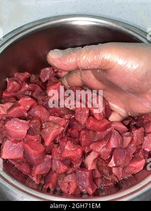 Fleisch im Topf in kleine Stücke geschnitten Stockfoto
