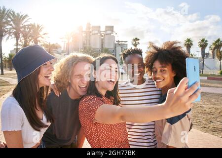 Eine Gruppe urbaner Jugendlicher genießt es, ein Selfie in der Stadt zu machen. Sie lächeln und Viel Spaß. Stockfoto