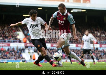 George McCartney von West Ham und Rafael Da Silva von Manchester United in Aktion während des Barclays Premier League-Spiels zwischen West Ham United und Manchester United am 22. März 2014 im Upton Park in London, England. Pic Charlie Forgham-Bailey Stockfoto