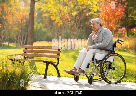 Einsamer älterer Mann, der auf dem Rollstuhl sitzt Stockfoto