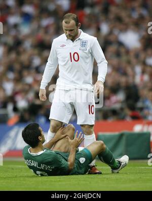 Der englische Wayne Rooney tünchelt mit dem slowenischen Aleksander Radosavljevic während des Internationalen Freundschaftsspiel zwischen England und Slowenien im Wembley Stadium, Großbritannien. Stockfoto