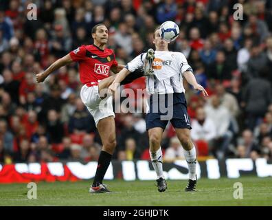 Rio Ferdinand von Manchester United trifft Bolton-Kevin Davies während des Spiels der Barclays Premier League zwischen Manchester United und Bolton Wanderers in Old Trafford. Stockfoto