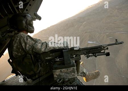 Ein Chef der Besatzung von CH-47 Chinook zieht Sicherheitskräfte von der Rampe des Hubschraubers ab, während er am 18. Dezember über der Provinz Paktika in Afghanistan fliegt. Stockfoto