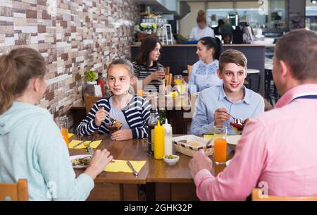 Familie mit Teenagern, die im Café essen Stockfoto