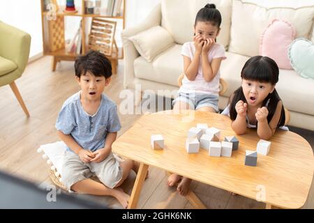 Nette Kinder, die im Wohnzimmer Fernsehen Stockfoto