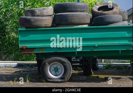 Stapel von gebrauchten Reifen in einem Pickup-LKW mit einem Platten Reifen Stockfoto