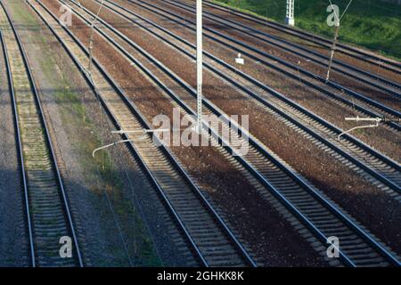 Blick auf die Eisenbahn von oben. Schienen für Züge. Ort der Bewegung des elektrischen Transports. Eisenbahn im Sommer. Stockfoto