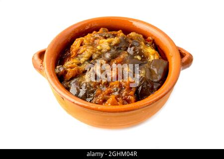 Türkische Auberginen mit Tomaten in einer Terrakotta-Schale auf weißem Hintergrund Stockfoto